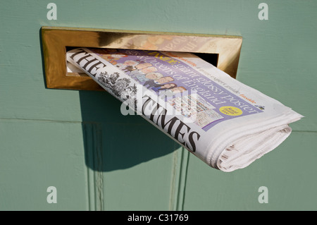 The Times newspaper sticking out of letterbox Stock Photo