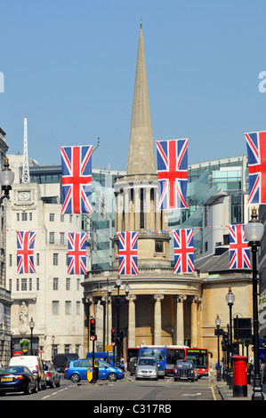 Traffic below union jack flag bunting in Regents Street with All Souls Church & spire in Langham Place BBC building beyond West End London England UK Stock Photo