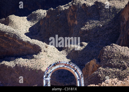 VERTICAL AERIAL VIEW. The Skywalk; a controversial, expensive tourist attraction built on the rim of the Grand Canyon. Arizona, USA. Stock Photo
