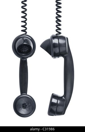 Old vintage phone with wear and tear hanging off the hook. Side and front view Stock Photo