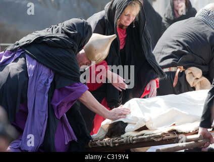 Crowds touching Jesus Easter Passion Play  body in Trafalgar Square Good Friday Stock Photo