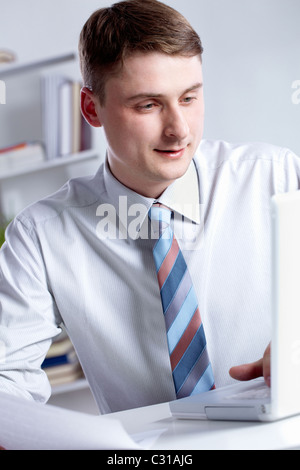 Portrait of serious manager looking at the laptop screen Stock Photo