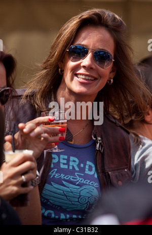 Portrait of a woman wearing sunglasses and holding a glass of wine, London, England, UK. Stock Photo