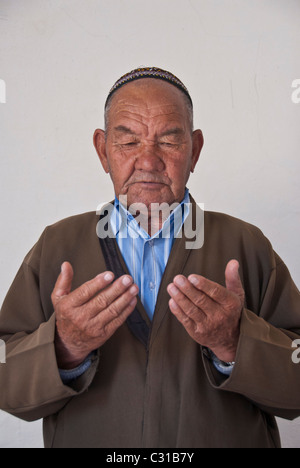 Senior Muslim man praying, Ashgabat, Turkmenistan Stock Photo