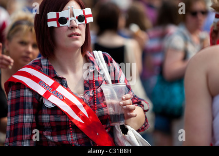 Woman wearing funny sunglasses, celebrating St George's Day at Trafalgar Square, London, England, UK Stock Photo