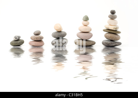 stone pebbles in line forming graph on white background Stock Photo