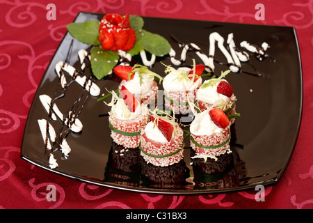 Tiramisu Sushi Roll garnished with Strawberry and Mint Stock Photo