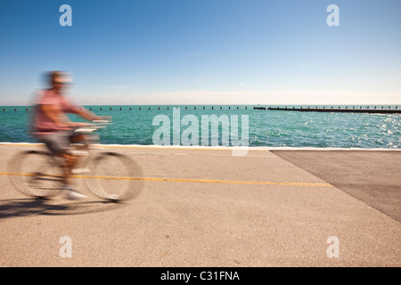 A bicyclist rides along Lake Michigan in downtown Chicago, IL. Stock Photo