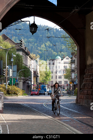 Germany, Freiburg, Woman riding bicycle, Freiburg is known as a bicycle ...