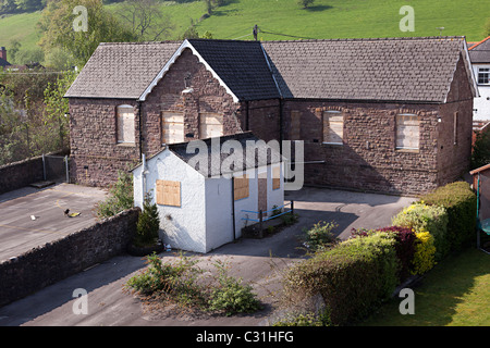 Boarded up closed down village primary school Llanfoist Wales UK Stock Photo