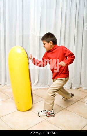 Pre-K 4-5 year old Hispanic boy learning healthy activity to release anger. MR © Myrleen Pearson Stock Photo