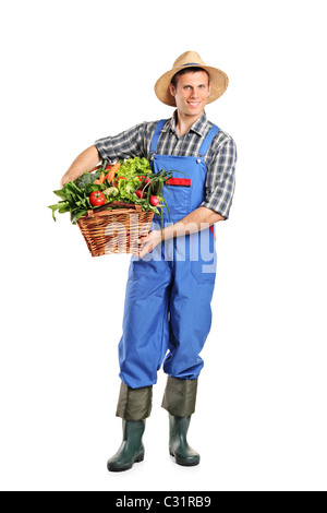Full length portrait of a farmer holding a basket full of vegetables Stock Photo