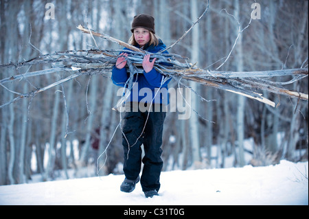 A boy collects firewood in the California backcountry. Stock Photo