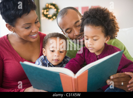 Black family reading book together Stock Photo