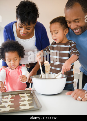 Black family baking cookies together Stock Photo
