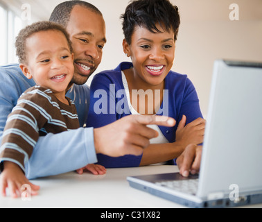 Black family using laptop together Stock Photo