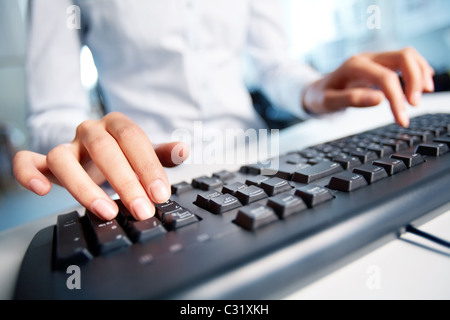 Image of female hands pressing computer keys at workplace Stock Photo