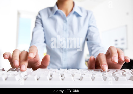 Photo of woman’s hands typing on keyboard in the office Stock Photo