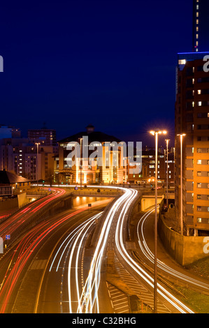 traffic light trails of vehicles traveling too and from the city of leeds at night yorkshire uk Stock Photo