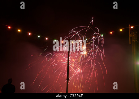 Fireworks display and coloured quayside lightbulbs at Fowey Regatta 2009, Cornwall, UK Stock Photo