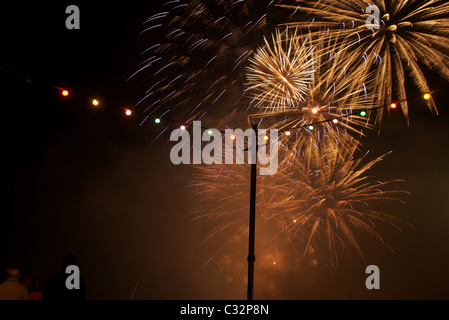 Fireworks display and coloured quayside lightbulbs at Fowey Regatta 2009, Cornwall, UK Stock Photo