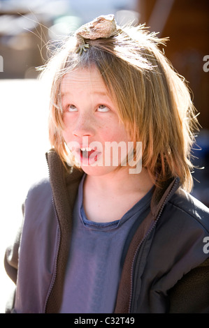 A boy poses with a bearded dragon while playing outdoors in Lake Tahoe, California. Stock Photo