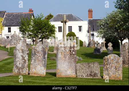 Gravestones and buildings in Ottery St Mary Devon, dead, grave, cross, crucifix Stock Photo