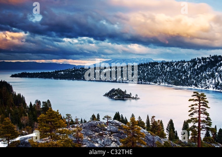 Clouds are illuminated at sunset over Emerald Bay in the winter, CA. Stock Photo