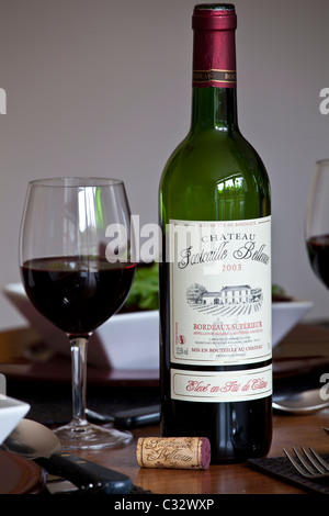 Bottle of French Bordeaux wine, Chateau Fontcaille Bellevue 2003 Grand Vin de Bordeaux and poured glass of wine, France