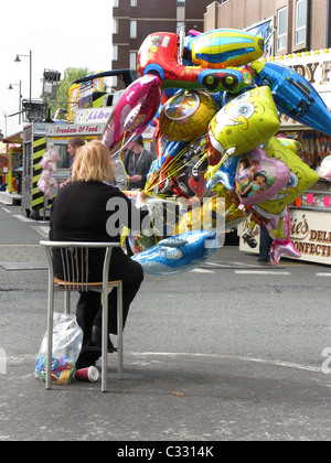 Balloon seller at fairground Stock Photo