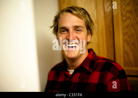 A young man wearing a red flannel jacket smiling at a camera in Camarillo, California. Stock Photo