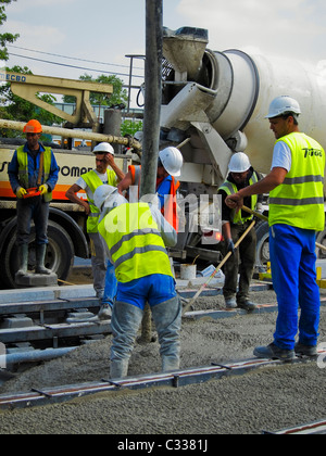 Paris, France, Tramway T3 Construction Site, Men Working in Concrete, Laying Tracks, Lafarge Cement Co., City Street, workers at construction site, International Immigrants, African Workers Stock Photo