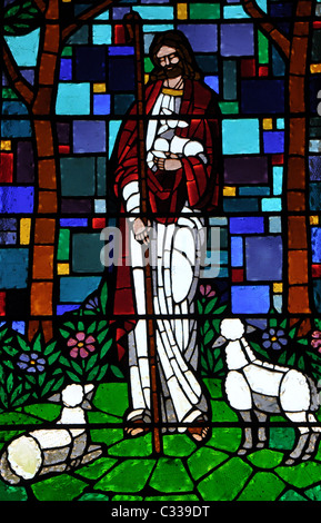A stainglass window of Jesus Christ holding a lamb Stock Photo