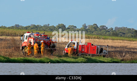 Volunteer Firefighters at their fire trucks after attending a grass fire. Pokolbin, Hunter Valley, NSW, Australia. Stock Photo