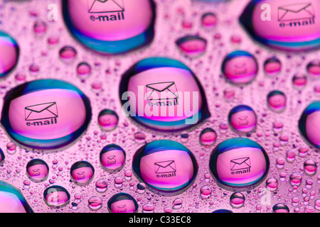 Envelope symbol reflected in the drops of water. Close-up of water droplets placed on a DVD disc Stock Photo