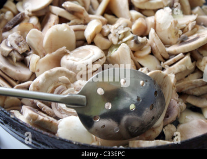 champinions frying on a pan Stock Photo