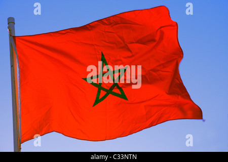 Morocco.s national flag flies on a pole against a cloudless springtime sky, Morocco, North Africa Stock Photo