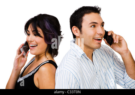 Smiling couple talking on mobile phones isolated over white Stock Photo