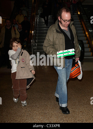 Cold Souls' star Paul Giamatti, carrying luggage and food from Sbarro, arrives at Salt Lake City airport with his son, Samuel Stock Photo