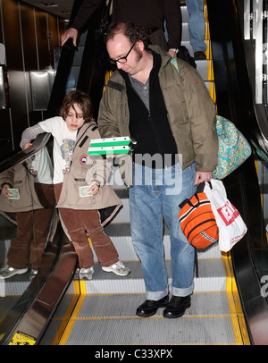 Cold Souls' star Paul Giamatti, carrying luggage and food from Sbarro, arrives at Salt Lake City airport with his son, Samuel Stock Photo