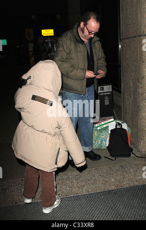 Cold Souls' star Paul Giamatti, carrying luggage and food from Sbarro, arrives at Salt Lake City airport with his son, Samuel Stock Photo