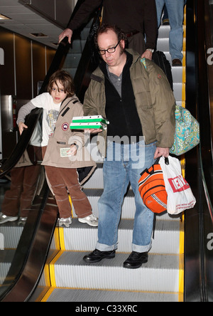 Cold Souls' star Paul Giamatti, carrying luggage and food from Sbarro, arrives at Salt Lake City airport with his son, Samuel Stock Photo