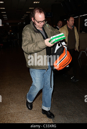 Cold Souls' star Paul Giamatti, carrying luggage and food from Sbarro, arrives at Salt Lake City airport with his son for the Stock Photo