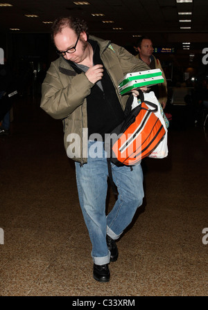 Cold Souls' star Paul Giamatti, carrying luggage and food from Sbarro, arrives at Salt Lake City airport with his son for the Stock Photo