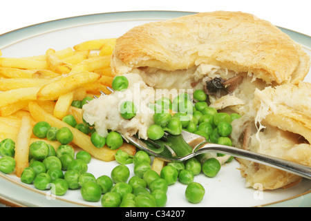 Chicken and mushroom pie with chips and peas on a plate Stock Photo