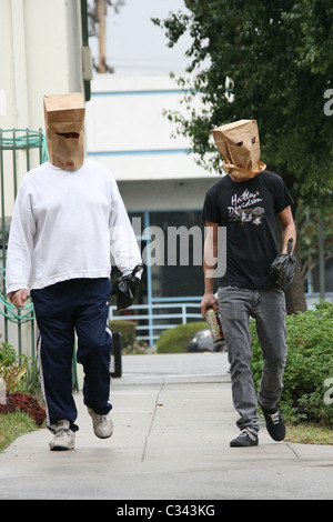 Shia LaBeouf tries to hide his identity by wearing a paper bag mask and plastic bag over his wrist cast as he takes a stroll Stock Photo