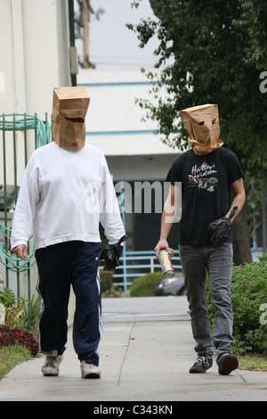 Shia LaBeouf tries to hide his identity by wearing a paper bag mask and plastic bag over his wrist cast as he takes a stroll Stock Photo