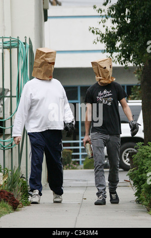 Shia LaBeouf tries to hide his identity by wearing a paper bag mask and plastic bag over his wrist cast as he takes a stroll Stock Photo