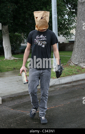 Shia LaBeouf tries to hide his identity by wearing a paper bag mask and plastic bag over his wrist cast as he takes a stroll Stock Photo