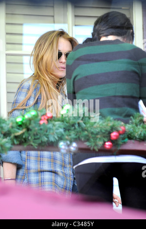 Lindsay Lohan smoking a cigarette with a friend on a private balcony above a farmers market Los Angeles, California - 07.12.08 Stock Photo